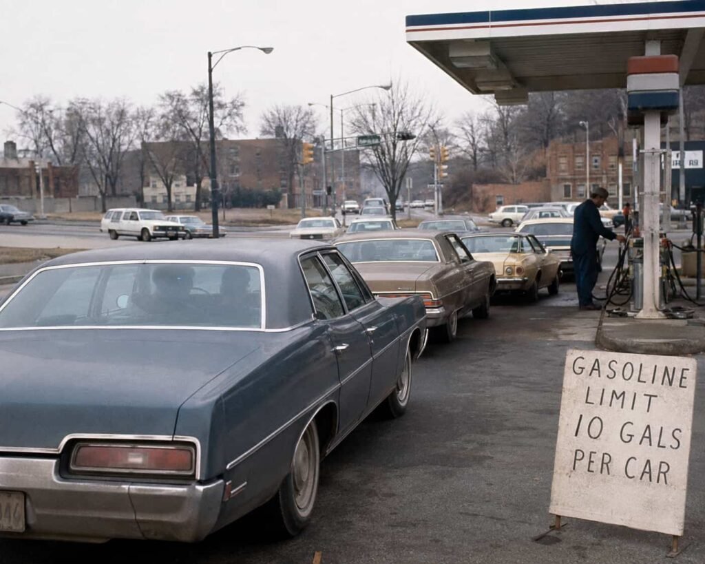 Cars waiting at an American gas station during the 1970s