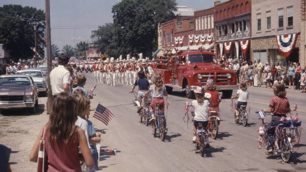 Small-town Fourth of July parade in the 1970s with flags and marching band