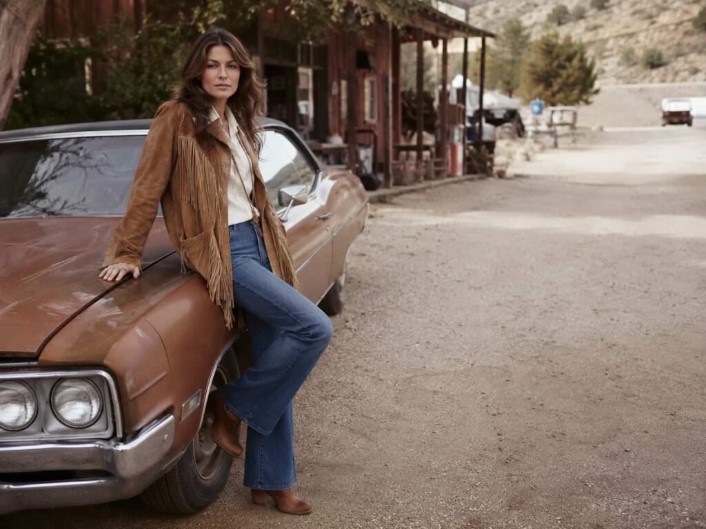 Woman wearing a tan suede fringe jacket in the 1970s