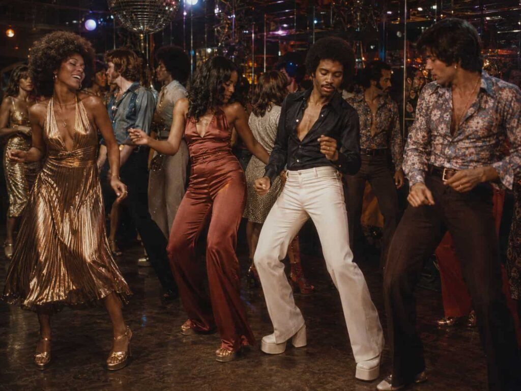 Adults dancing in authentic late-1970s disco clothing