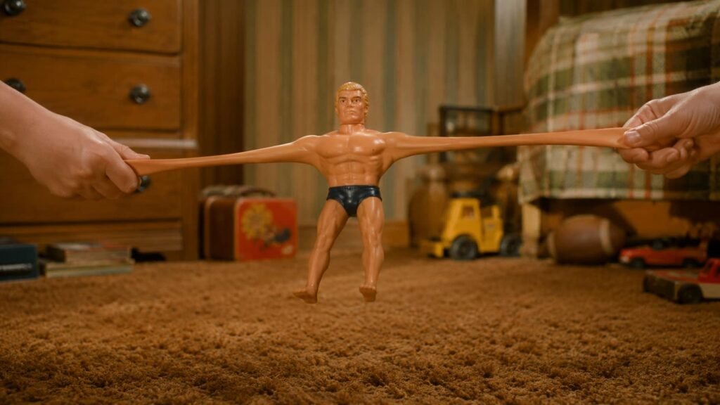 Stretch Armstrong figure being pulled across a shag carpet